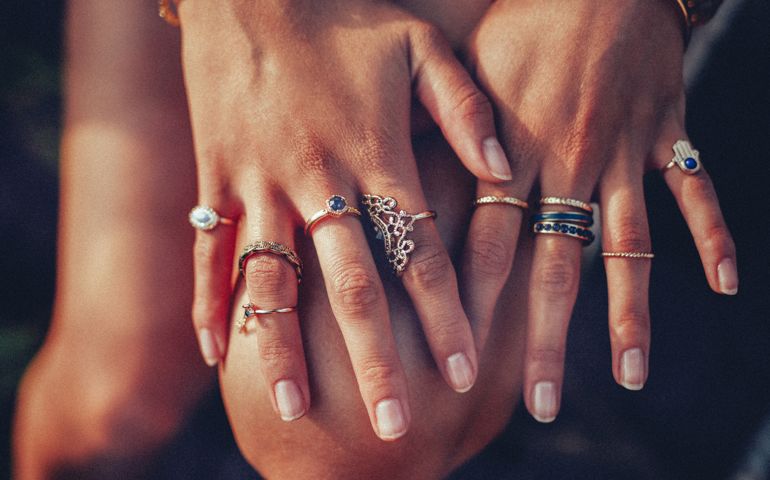 Boho girl's hands looking feminine with many rings