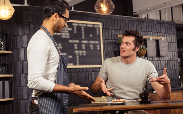 Waiter and customer having a discussion