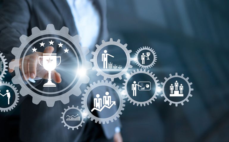 Business mechanism concept. Businessman touching trophy winner successful and business processes workflows in gears icons on virtual screen