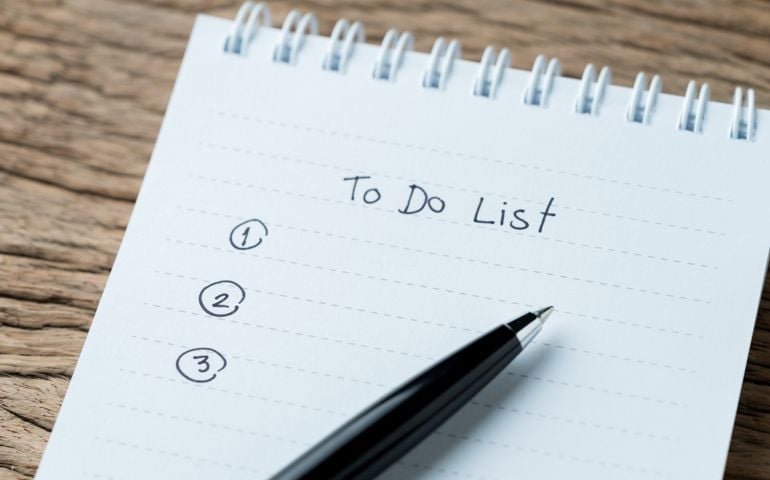 To do or writing tasks priority concept, closed up of list on numbers with pen and headline as To Do List on white paper notepad on wood table in soft tone