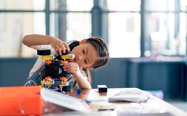 Young girl working on a robot design
