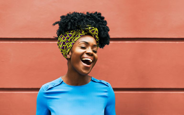 Happy woman infront of wall