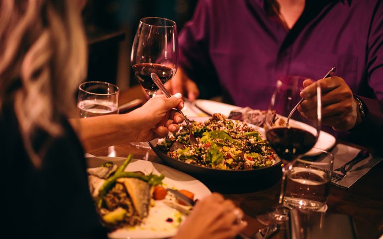 Couple eating quinoa salad and healthy dinner at restaurant