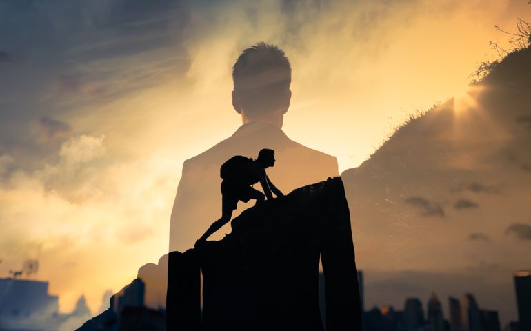 person climbing up hill
