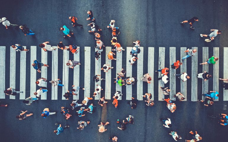 aerial view of people crossing crosswalk