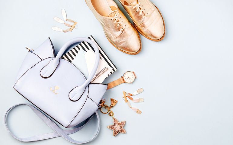 Cute blue ladies bag, stylish golden shoes and feminine accessories . Flat lay, top view. Spring fashion concept in pastel colored