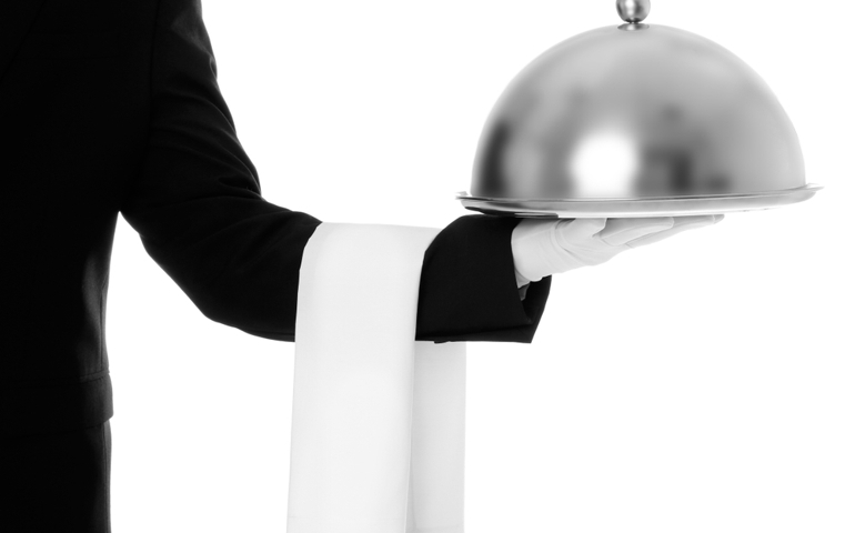 Waiter holding metal tray with lid on white background, closeup