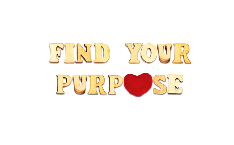 find your purpose phrase composed with wooden letters isolated on white background with red heart symbol