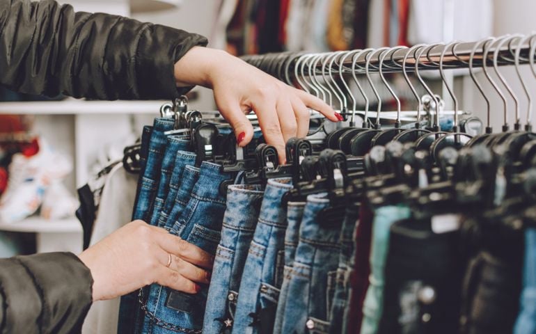 Person looking through jeans in the store