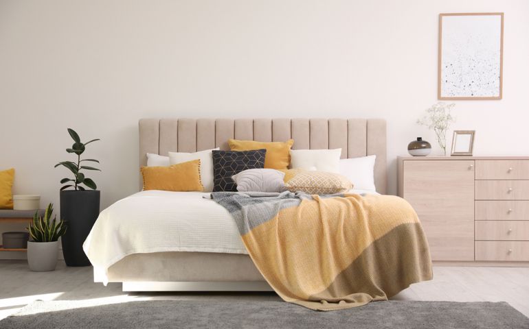 Stylish interior of contemporary room with comfortable bed