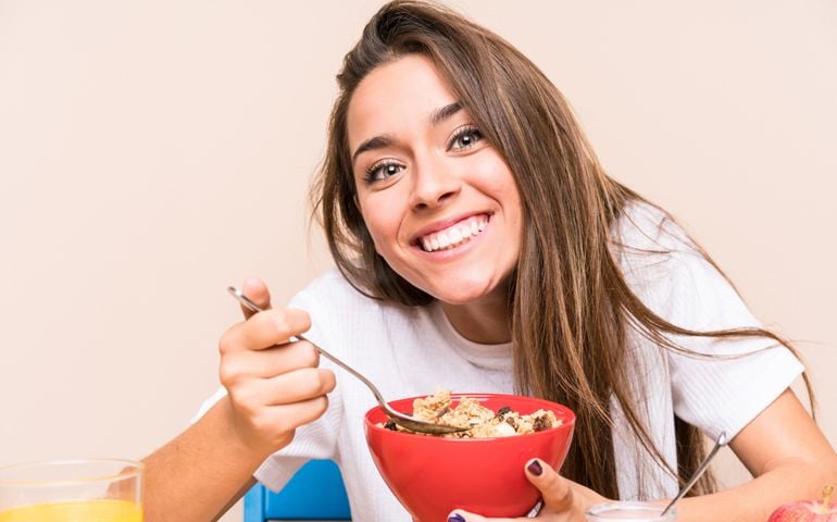 Young caucasian woman having breakfast