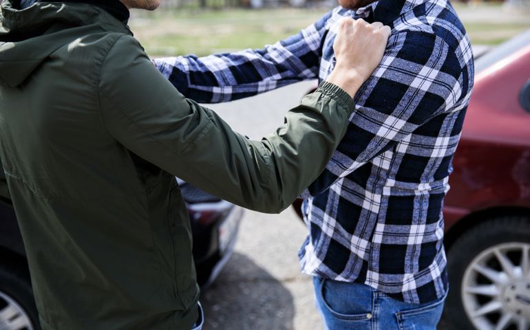 car crash and two men fighting in street