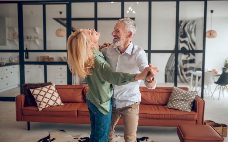 Dancing. Nice couple dancing in the room and looking happy