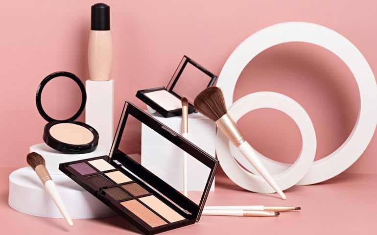 Make up products prsented on white podiums on pink pastel background. Mockup for branding and packaging presentation