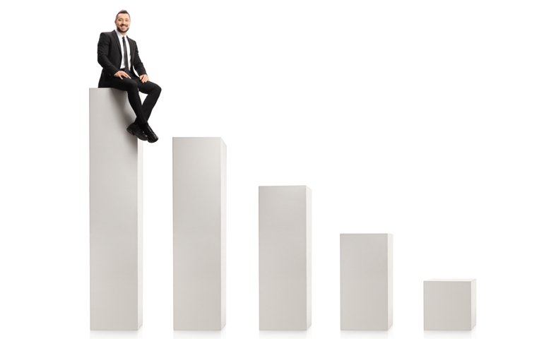 Businessman sitting on the highest column in a chart isolated on white background