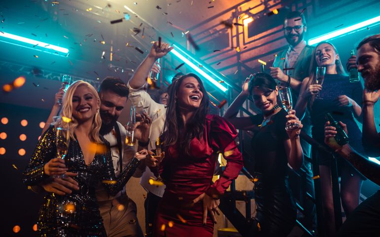 Group of friends partying in a club and moving to the music.