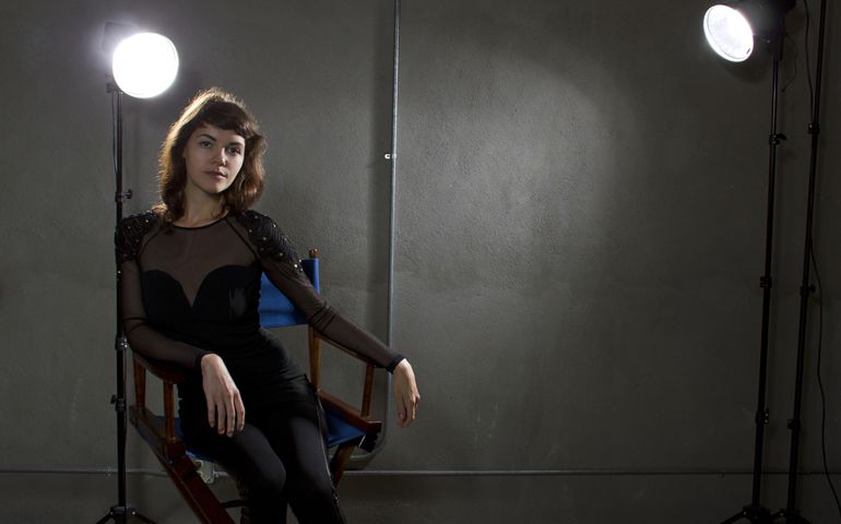 young female actress sitting on a directors chair