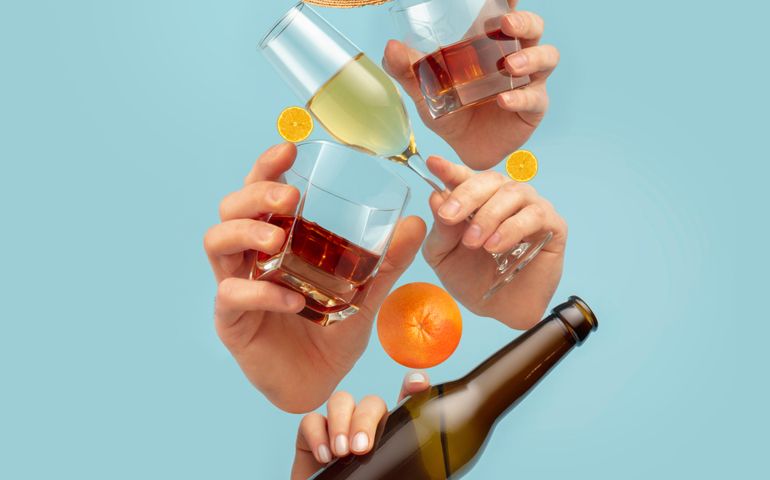 Drinks of your choice. Modern composition in magazine style with human hands holding glasses for alcohol drinks over blue background. Copyspace for ad, offer