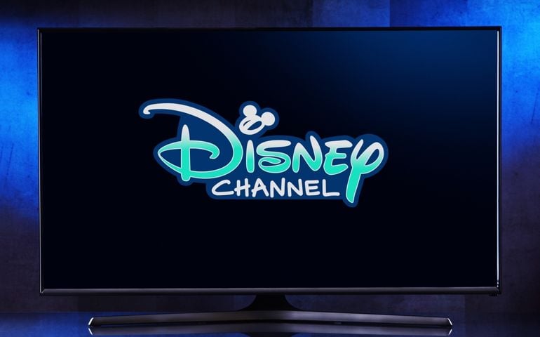 POZNAN, POL - MAR 25, 2022: Flat-screen TV set displaying logo of Disney Channel, an American pay television channel that serves as the flagship property of owner Disney Branded Television