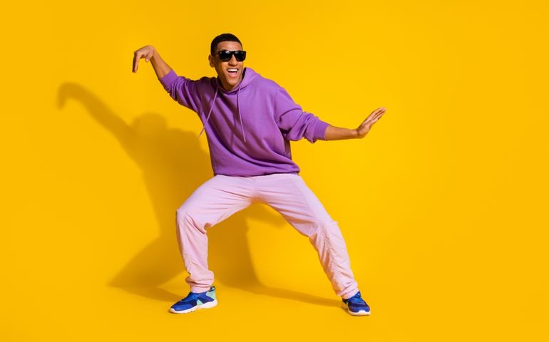 Full length body size view of attractive cheerful guy fooling dancing clubbing isolated over bright yellow color background