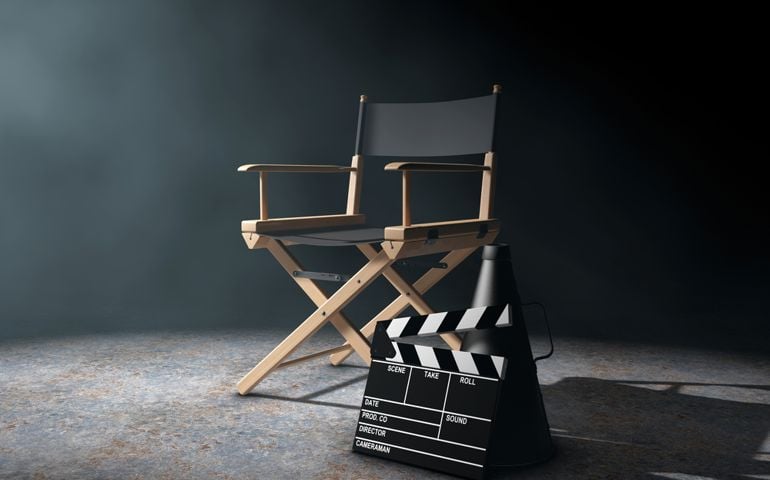 Director Chair, Movie Clapper and Megaphone in the volumetric light on a black background. 3d Rendering