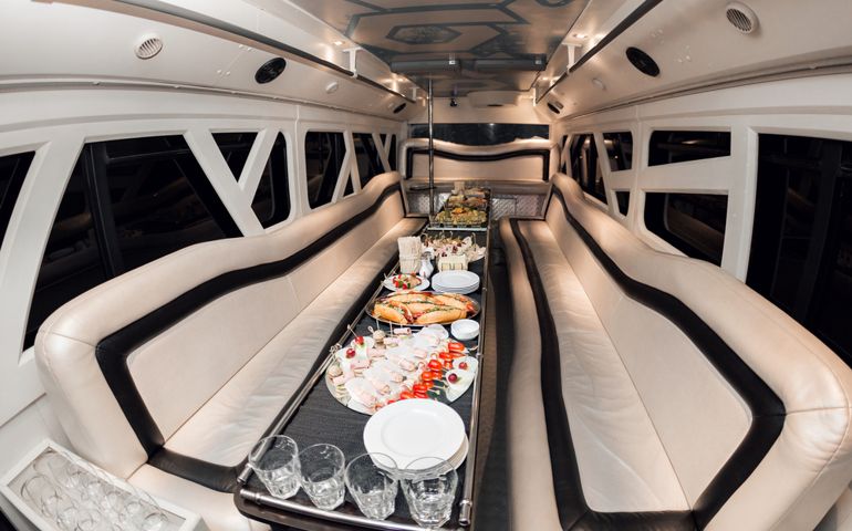 Interior inside the limousine. with sofas and a table covered with snacks for the holiday. Selective focus