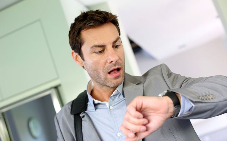 Businessman running late for work
