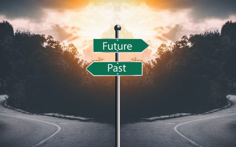 Two way junction with "past and present" sign in the middle. Meant to symbolize moving on and not looking a the past