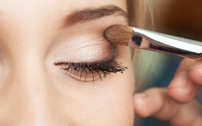 Eye makeup woman applying eyeshadow powder