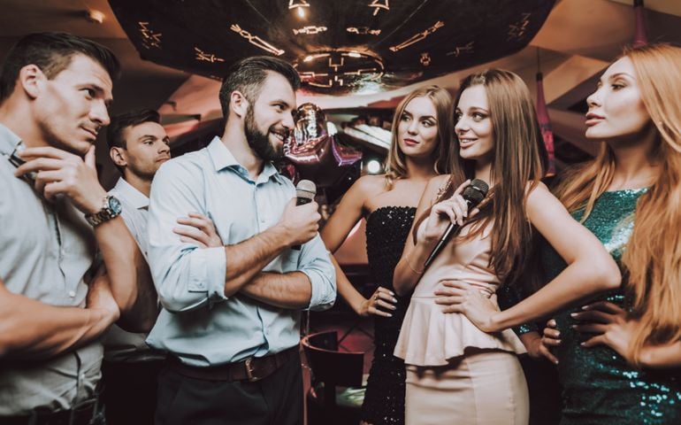 Battle. Cheerful. Singing Songs. Have Fun. Beautiful Girls. Friends at Karaoke Club. Karaoke Club. Celebration. Young People. Party Maker. Girls Sing. Smile. Trendy Nightclub. Smiling Girl.
