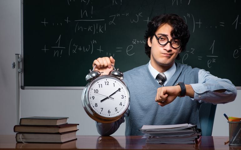 Young math teacher in front of chalkboard