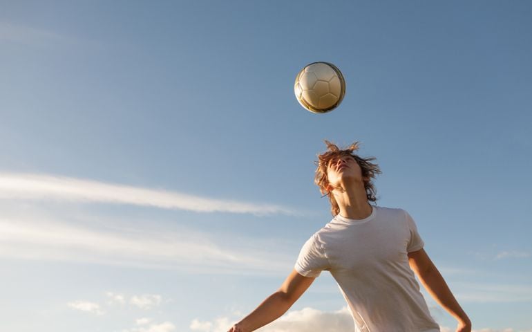 Young men hitting the soccer ball