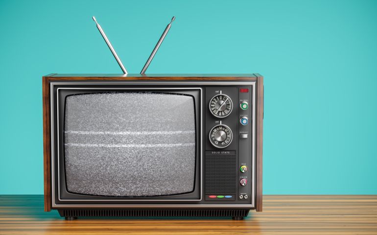 An old TV with a monochrome kinescope on wooden table