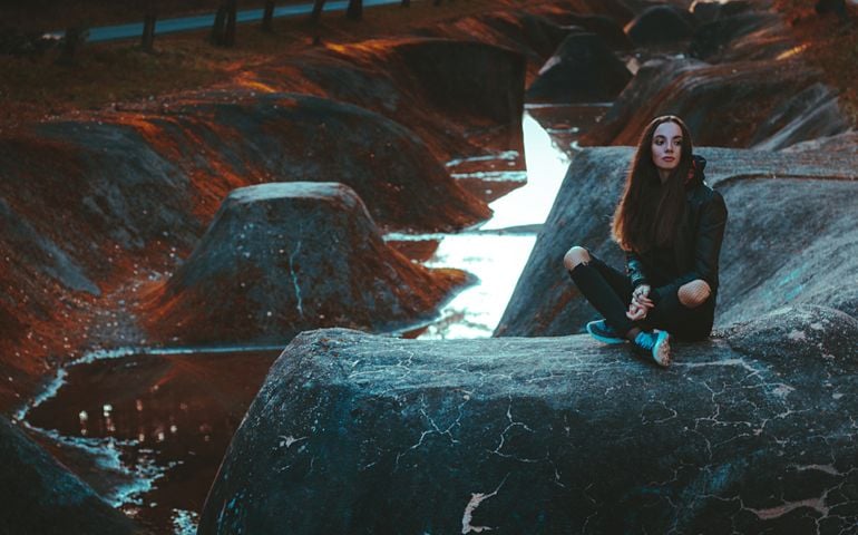 Post apocalypse. Another life, a lost world. Girl in a strange place in the paranormal world. Retrowave. Mystery forest, mystical atmosphere. Dark wood. Background wallpaper. Horrible dream.