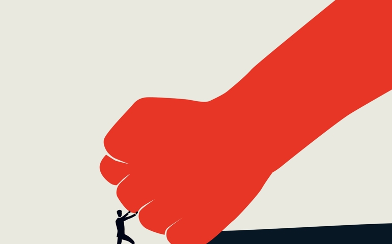 business concept with small man fighting big fist