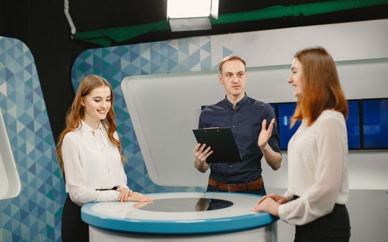 Tv host and two participants on game show