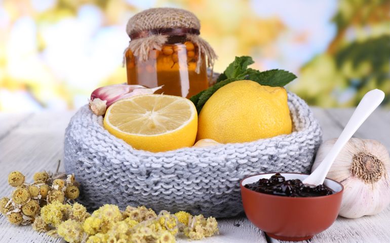 Folk remedies for colds on table on natural background
