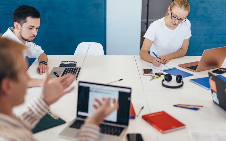Employees communicate at work by sitting at a communal table