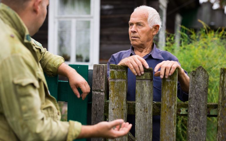 Senior man having conversation with his neighbour