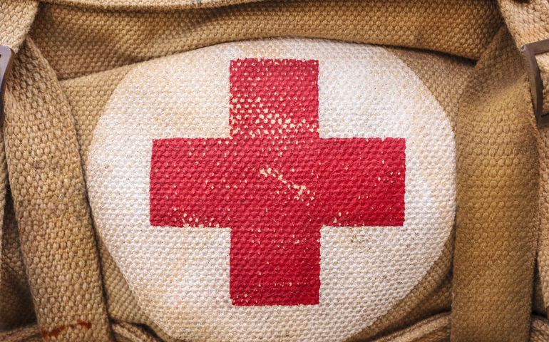 medical aid symbol on a vintage jute army bag