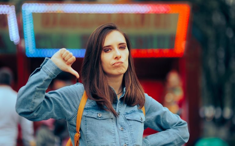 Unhappy Girlfriend Showing Thumbs Down for Negative Response. Girl saying no and disapproving being critical