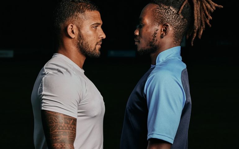 Profile, rival and a sports black man facing his opponent while looking serious in studio on a dark background. Face, challenge or conflict with a male athlete and competitor ready for competition