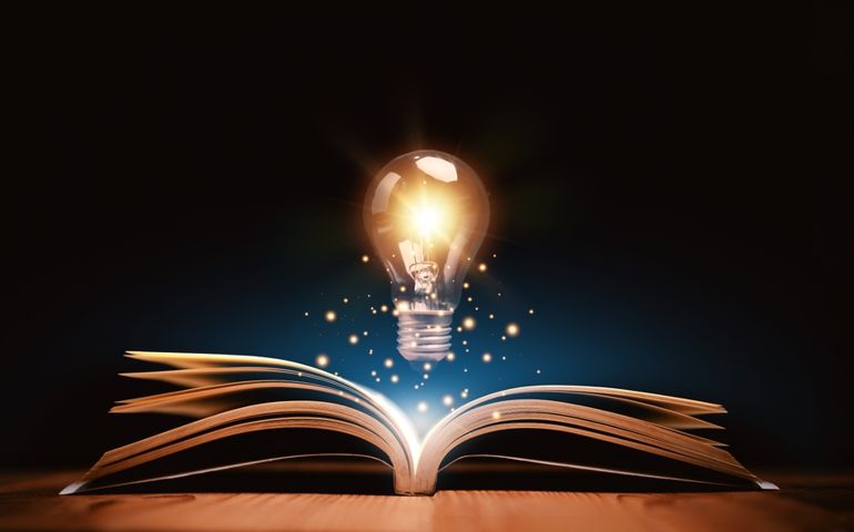 Glowing lightbulb over a book, Inspiring from read concept