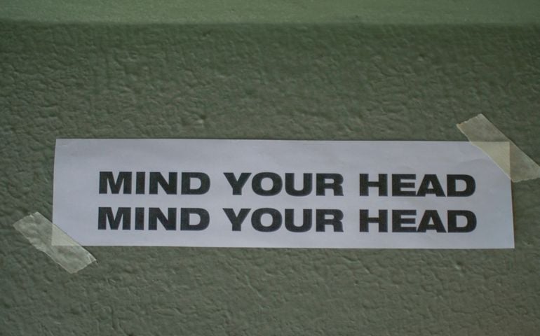 Mind Your Head sign Above Doorway or foot step. Low up ceiling caution, head lowering instruction, drop hazard