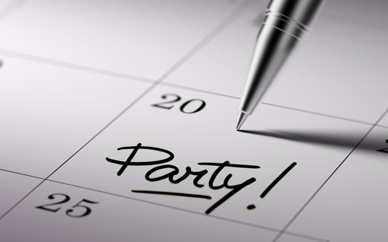 Closeup of a personal agenda setting an important date written with pen. The words Party written on a white notebook to remind you an important appointment.