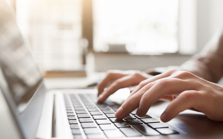 Typing on laptop closeup
