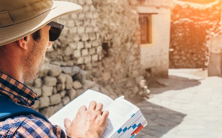 Close up image tourist with guide book on asian street