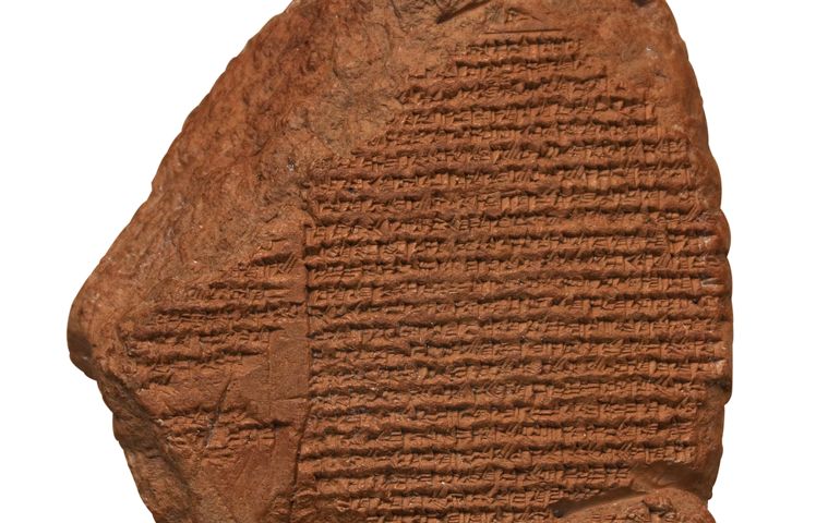 Clay tablet with cuneiform writing of the ancient Sumerian or Assyrian civilization isolated on white with clipping path