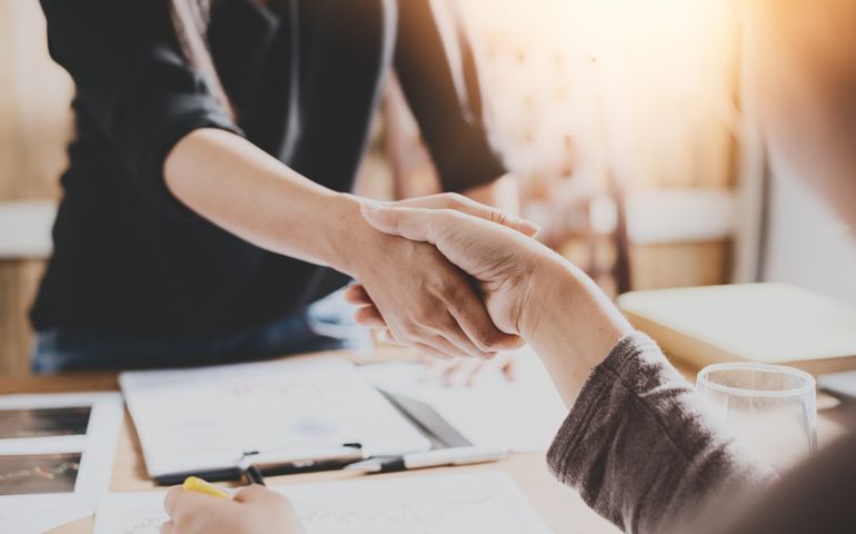 Negotiating business,Image of businesswomen Handshaking,happy with work,the woman she is enjoying with her workmate,Handshake Gesturing People Connection Deal Concept