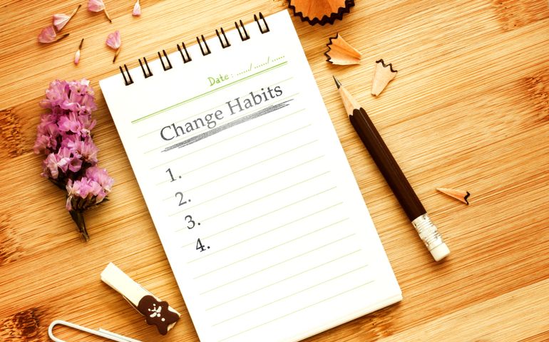 notepad with pencil on wooden table for change habits list concept , overhead shot or Top view